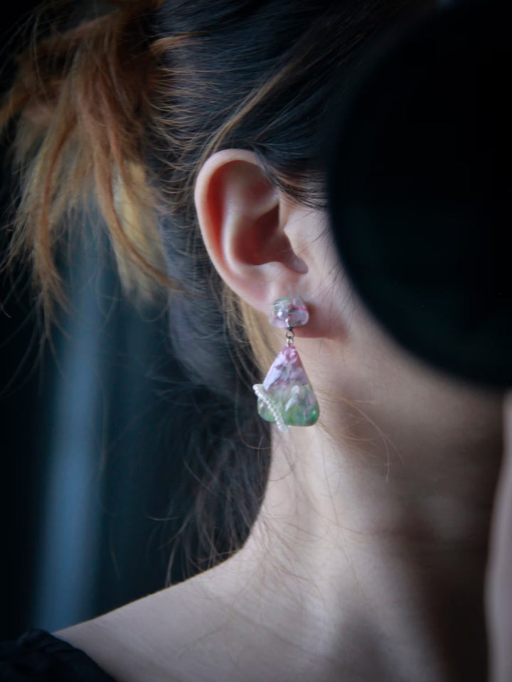 Handcrafted resin statement earrings in translucent pink and green with pearl accents and wrapped bead details from the Imagined Objects collection by Artist Jun.