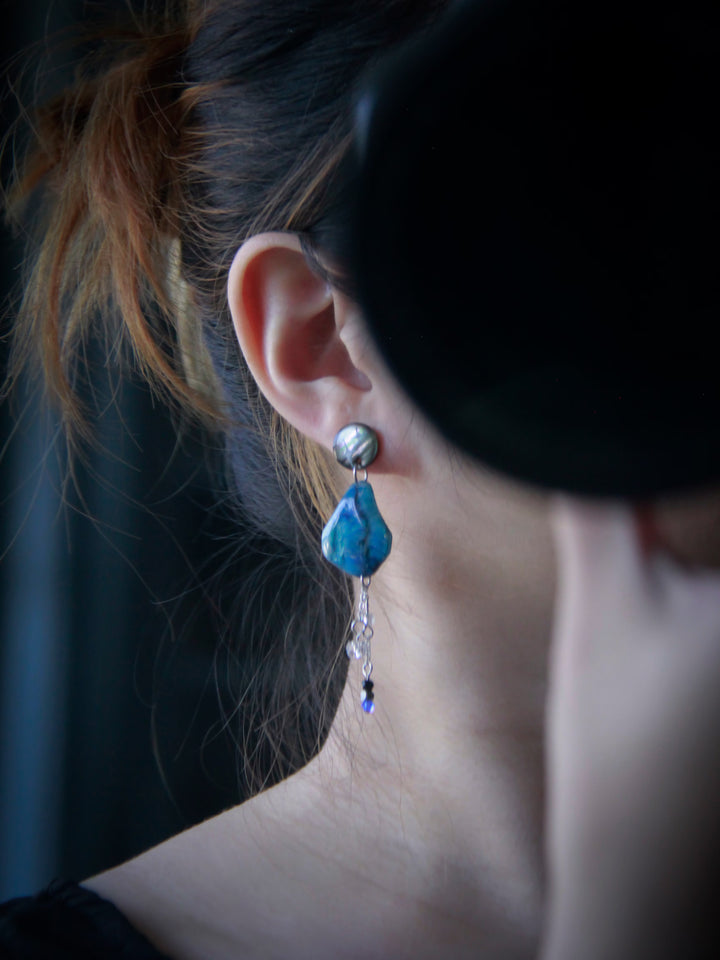 ASC-001 sculptural earrings worn on ear for size reference