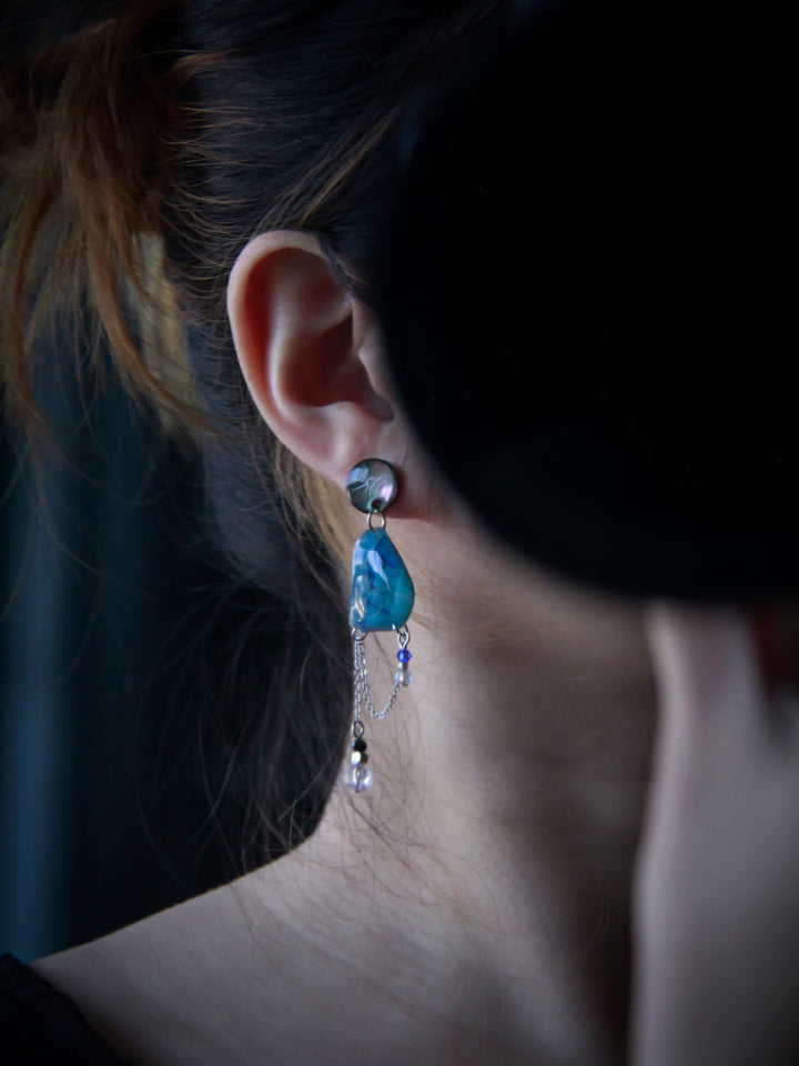 ASC-001 sculptural earrings worn on ear for size reference